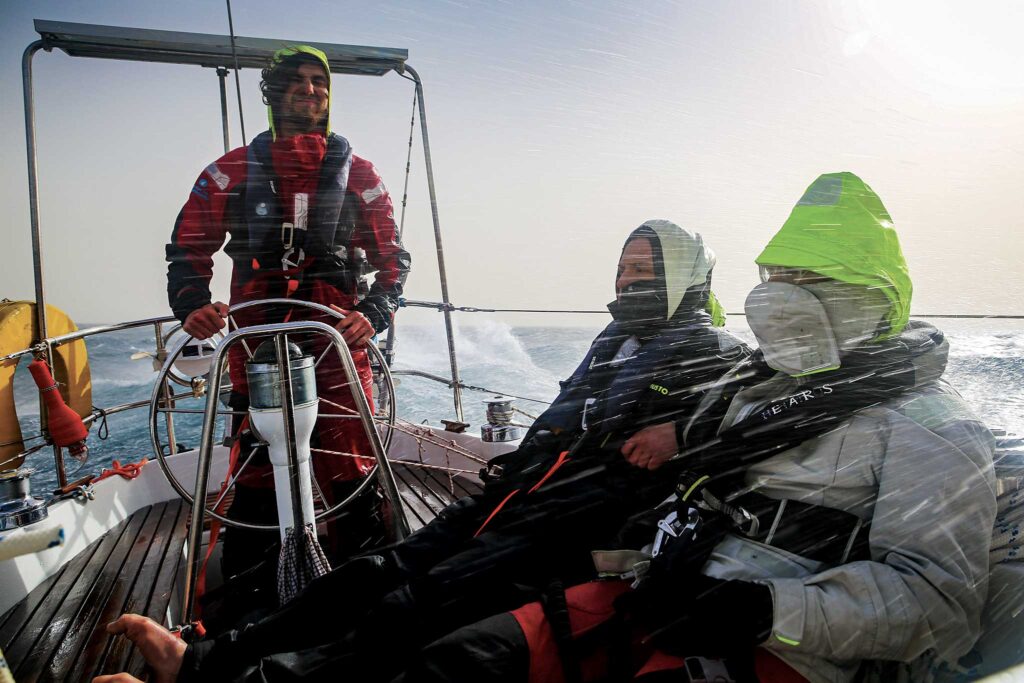 Harry steers while Max and Chloë endure some weather in the Canary Islands. Photo Courtesy of Max Campbell