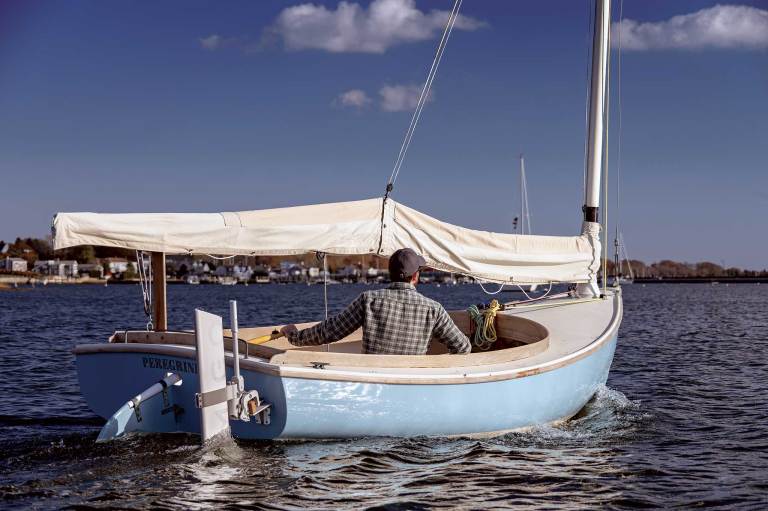 00-Electric-OB-07 A man sailing a dinghy with an electric motor