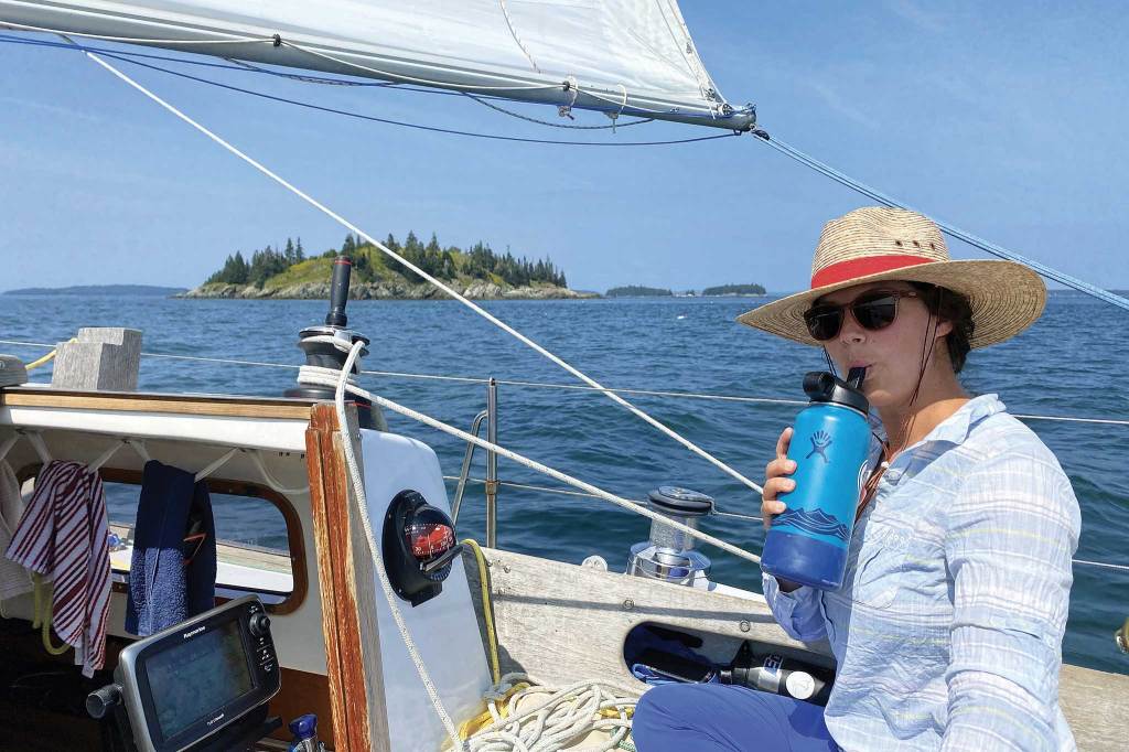 Woman wearing a hat on a boat.