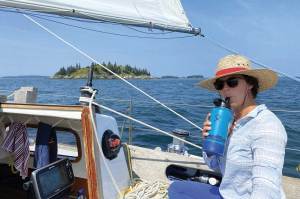 Woman wearing a hat on a boat.