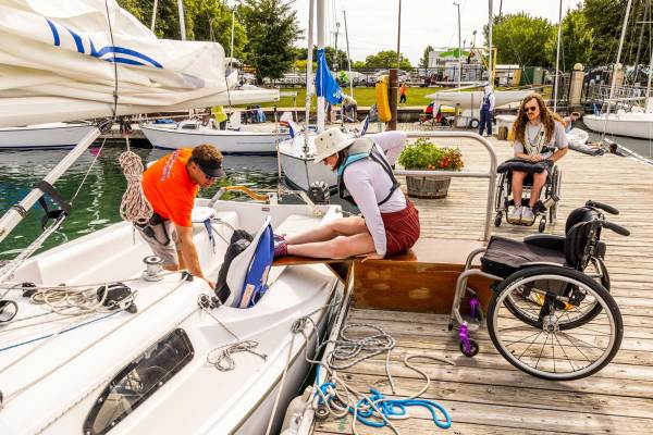 A boat dock at a pier with people waiting to board