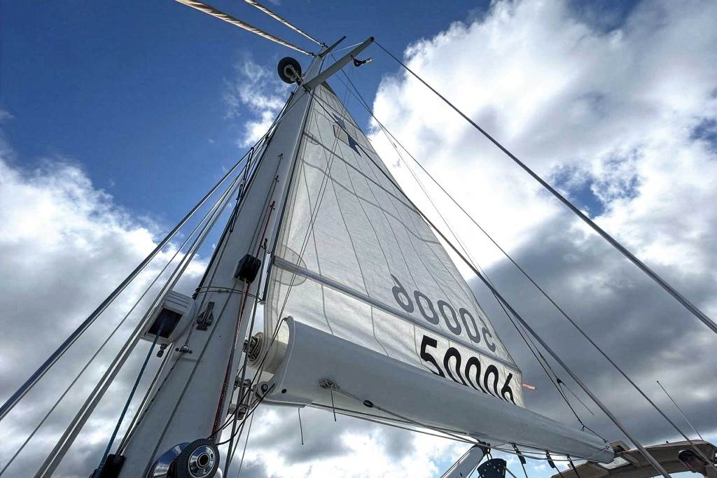 sailboat with a white sail showing the winch