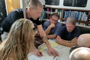 The author demos navigation skills on paper charts.